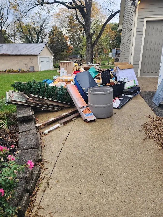 Dumpster being loaded with debris for 10 Yard Dumpster Rental in Havre